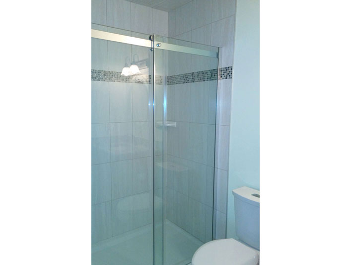 Tiled shower with glass doors