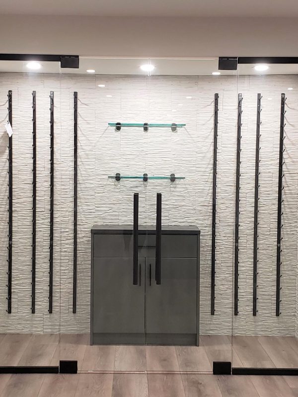 Glass wine display cabinet featuring stone tile backsplash