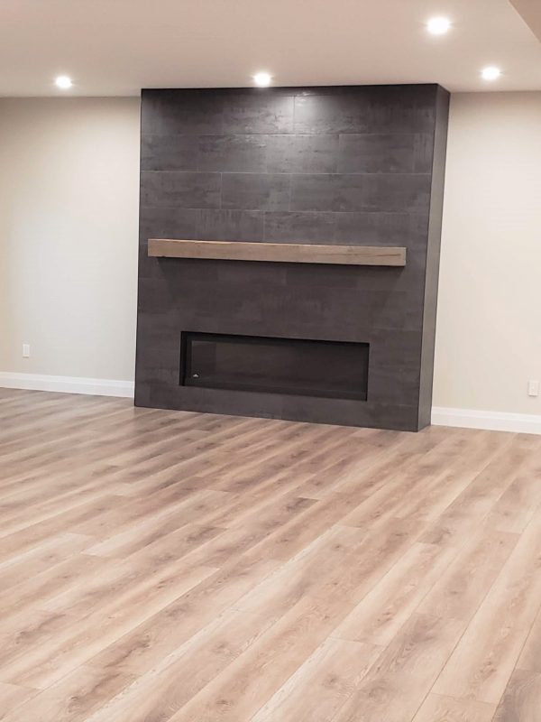 Porcelain tile fireplace surround featuring distressed wood mantel