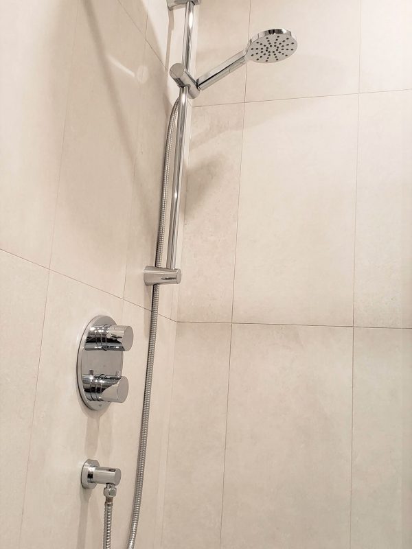 Handheld shower system with rain shower