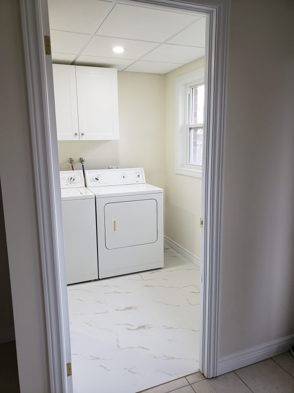 Laundry room renovation featuring luxury vinyl tile