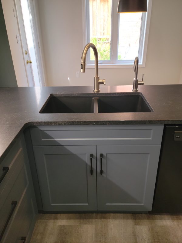 Granite sink in pearl black featuring chrome faucets