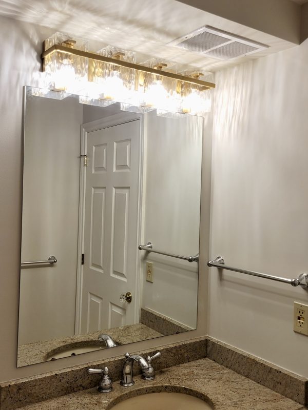 Wall light above vanity replaced in main washroom