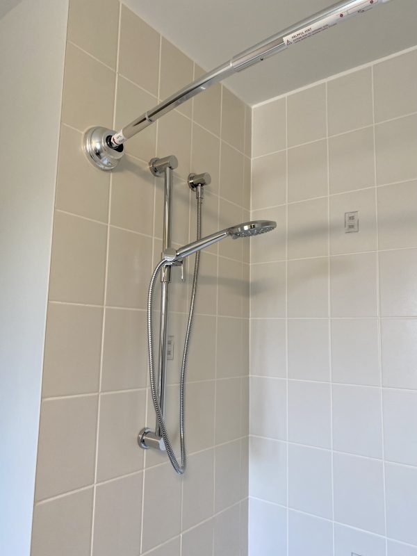 Handheld slide bar was installed with an updated shower rod