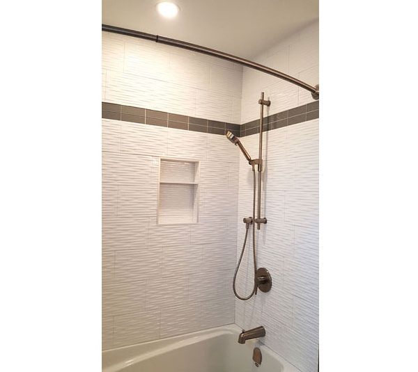 Bathtub/shower with white tile surround