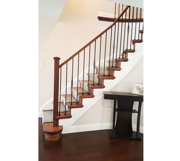 Oak stair system and railing with iron spindles and carpet runner