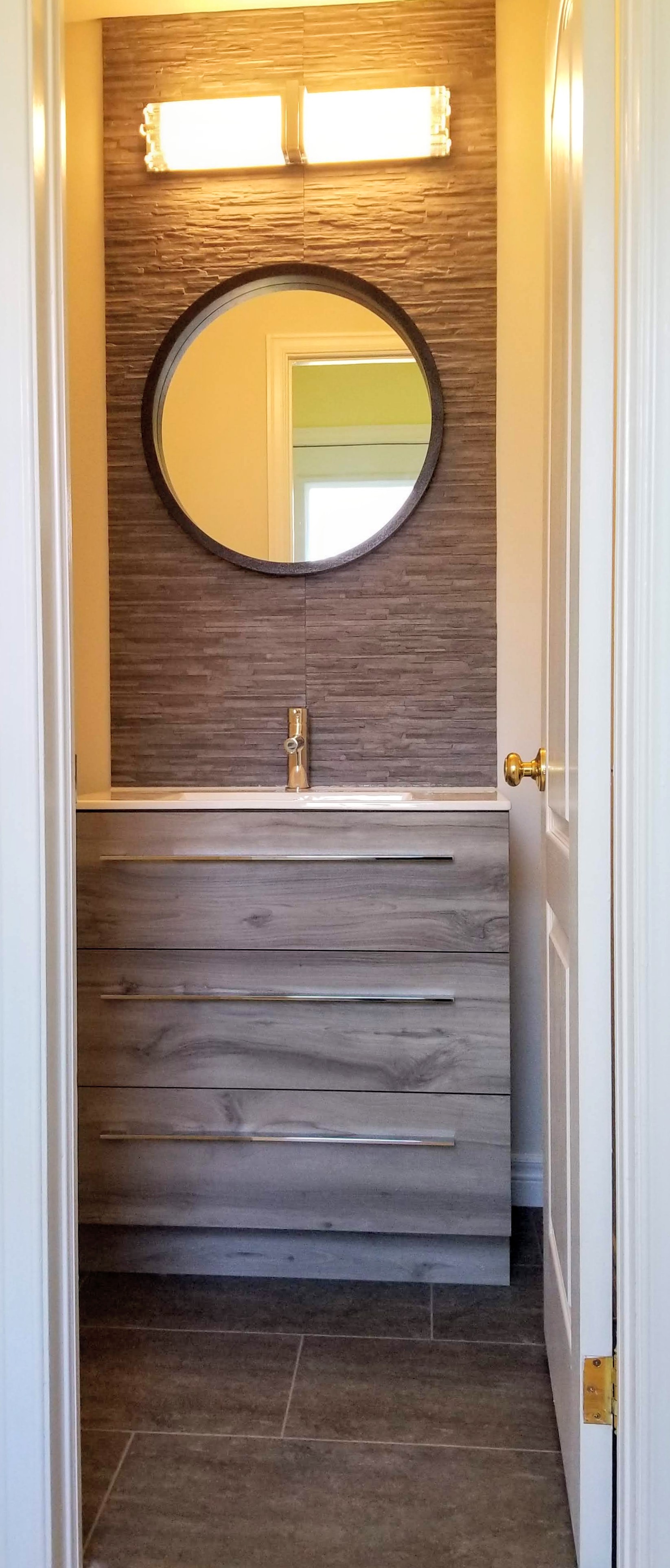 Grey bathroom vanity with accent tile wall