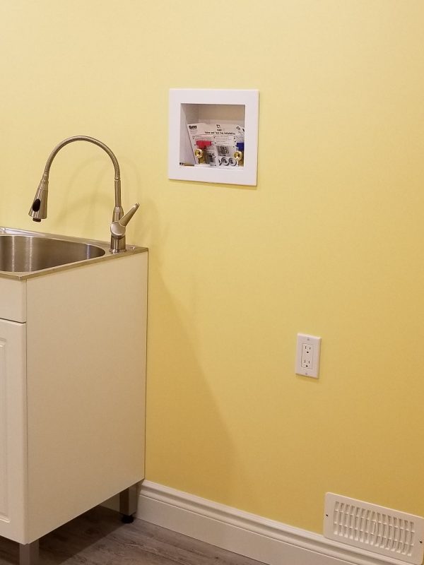 Bright yellow basement laundry room