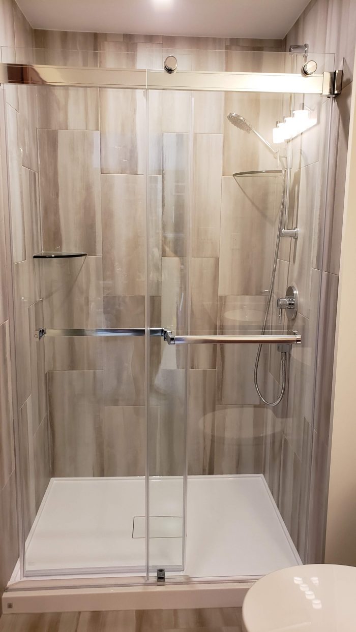 Glass bypass shower system with acrylic base
