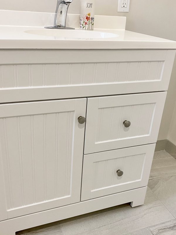 White vanity with door and drawers