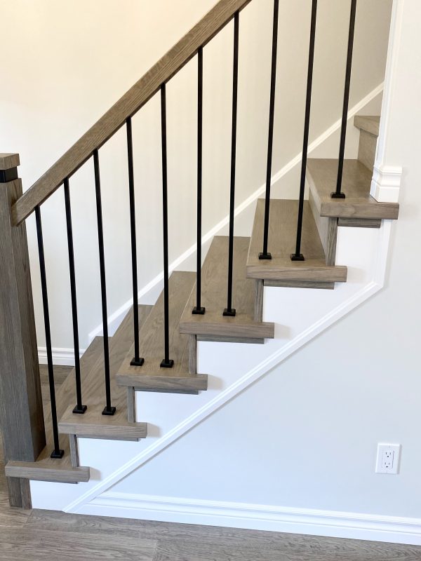 Engineered hardwood stairs featuring iron spindles