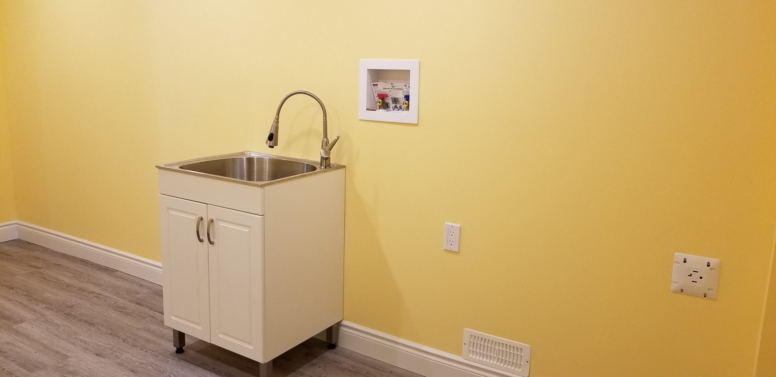 Bright yellow basement laundry room