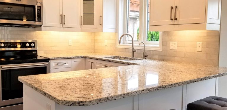 Ornamental white granite countertops with marble backsplash tile
