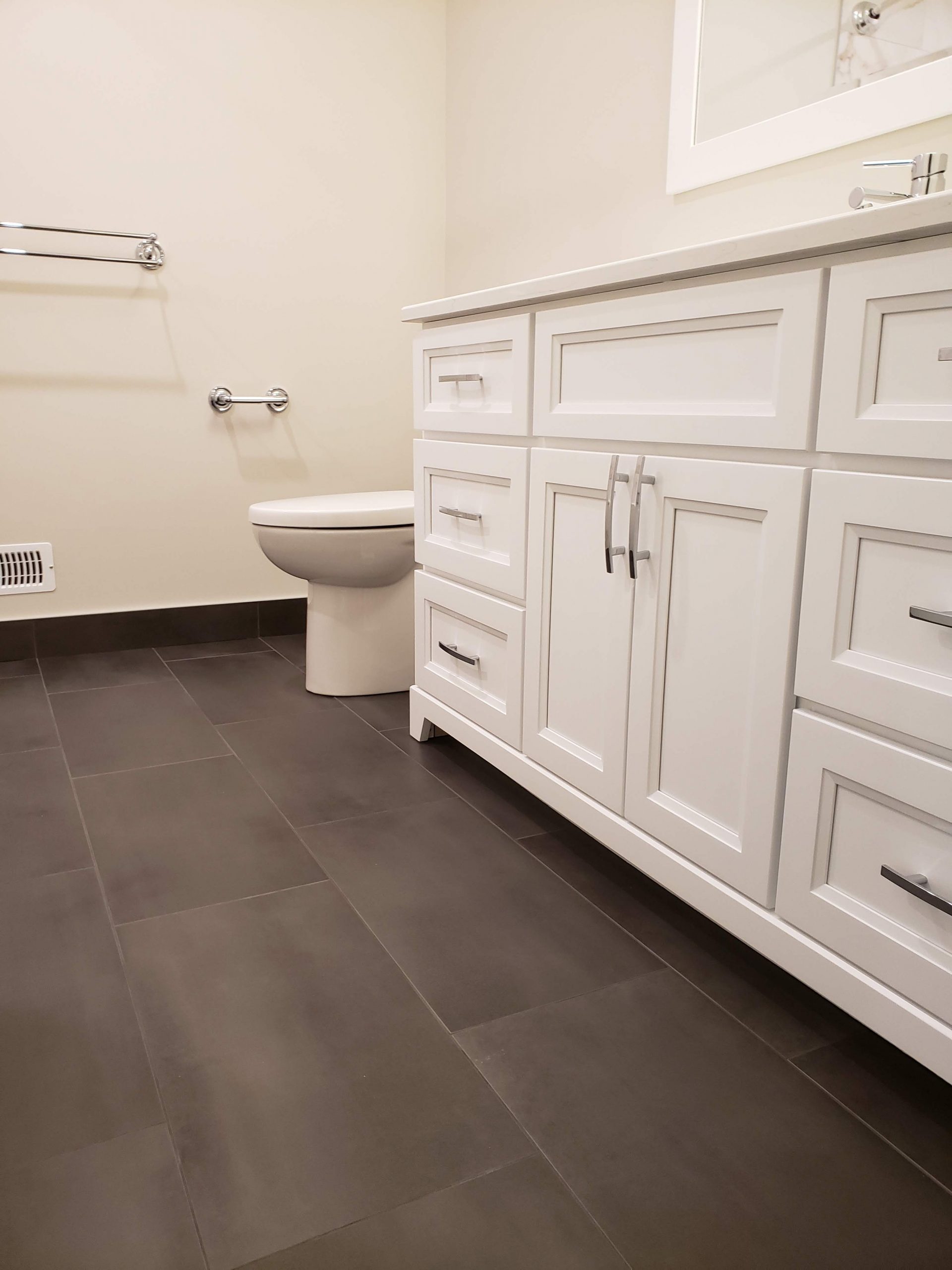 White vanity featuring quartz countertops