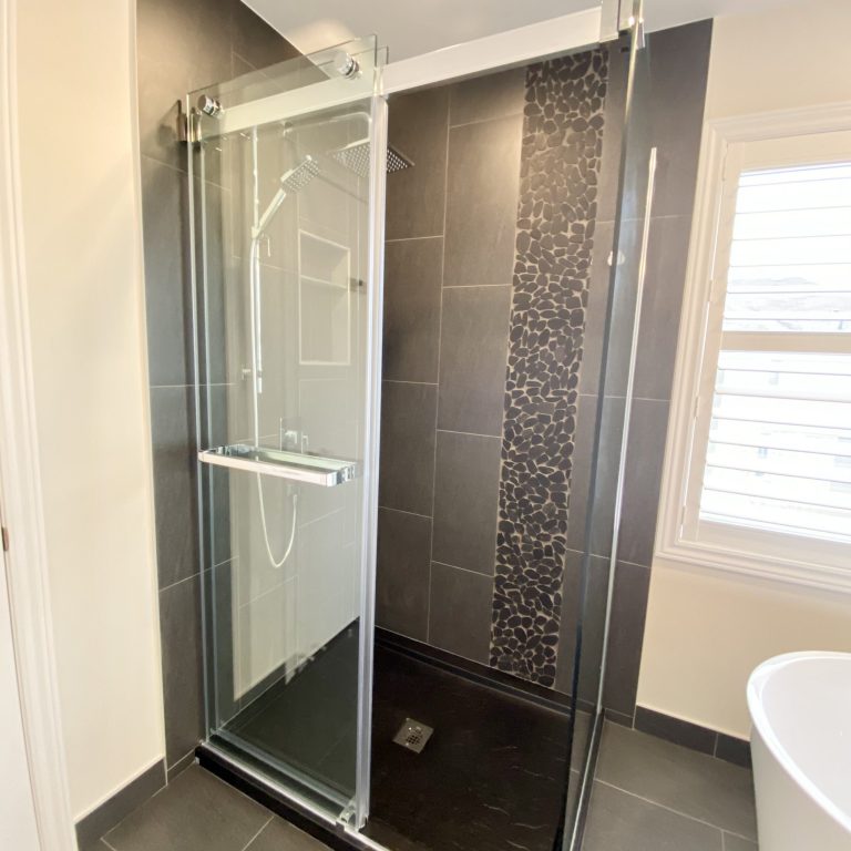 Sliding glass door shower that is accessible from both sides