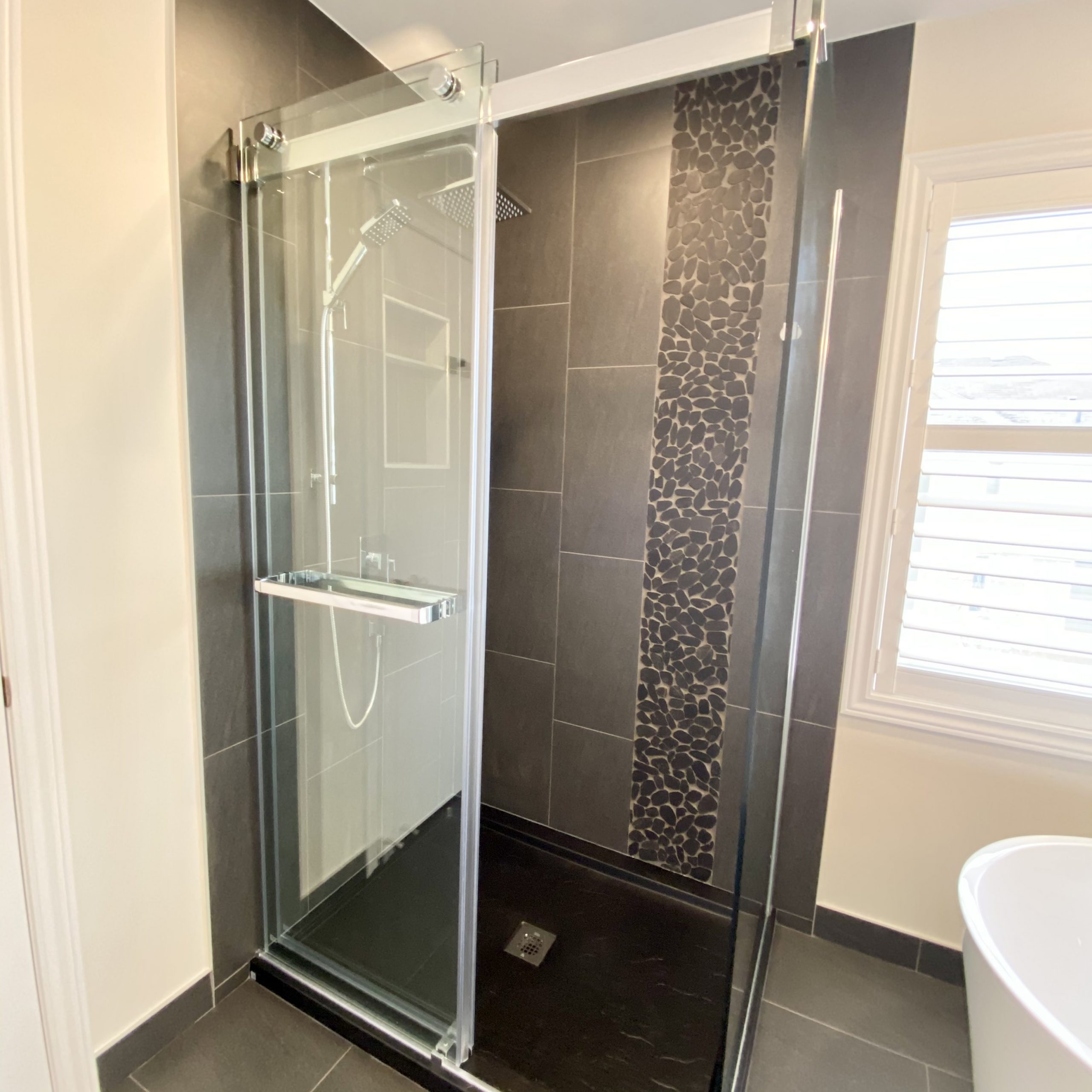 Sliding glass door shower that is accessible from both sides
