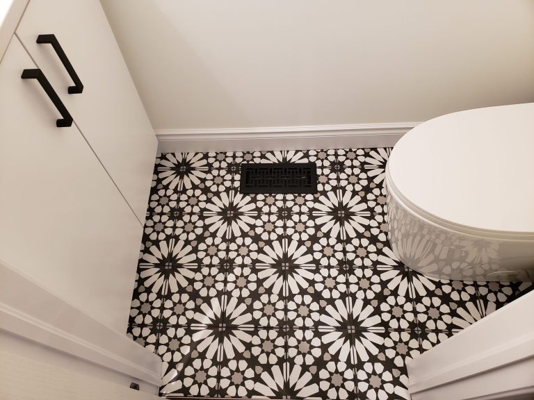 Mosaic tiles were installed with white baseboards