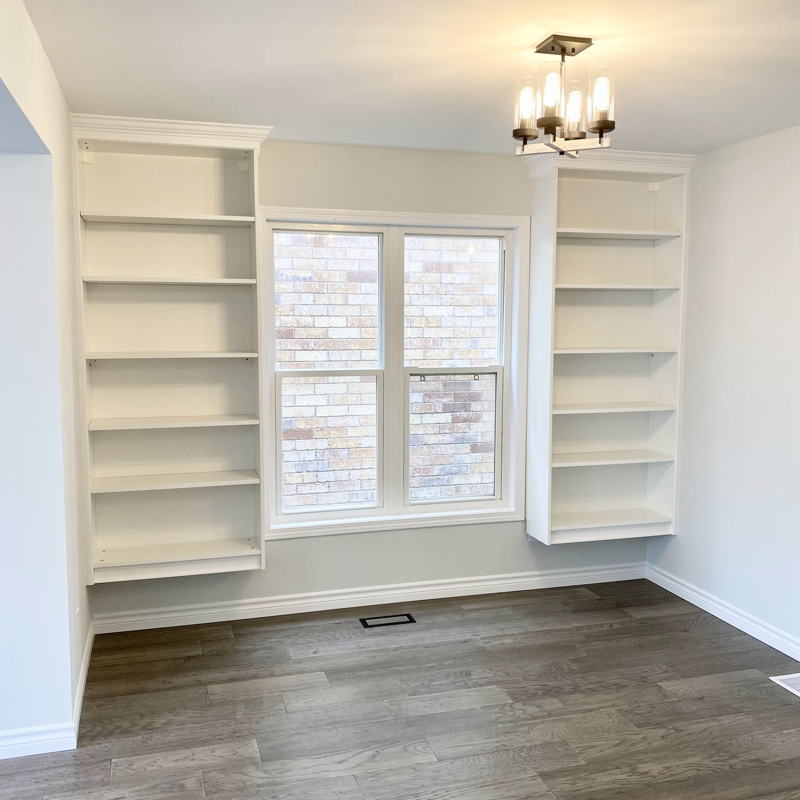 Floating bookcase shelving installed in 'library' area