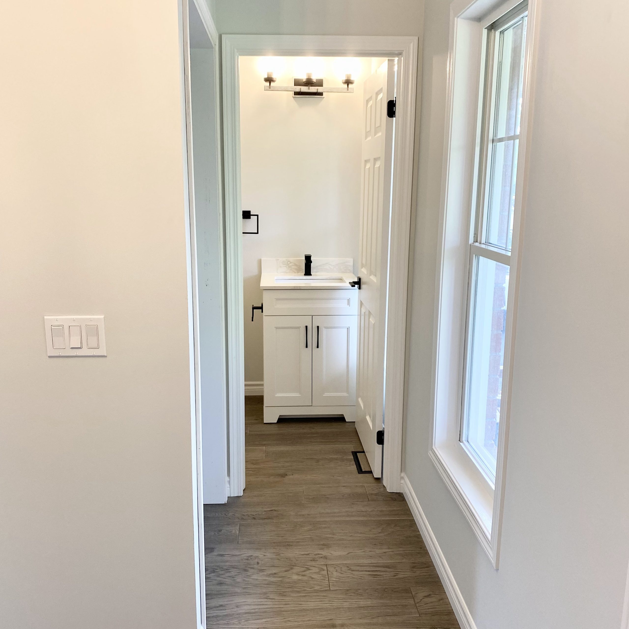 Powder room featuring white and black fixtures