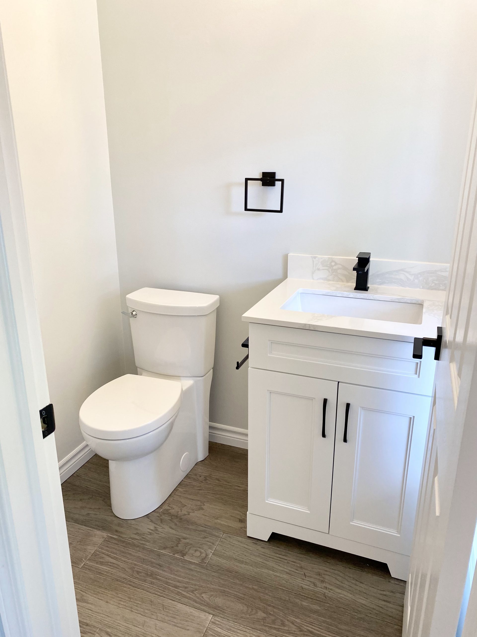 Powder room featuring black hardware
